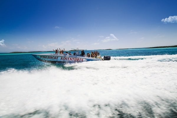 A Powerboat Adventures speed boat rides through the turquoise waters of The Bahamas. 