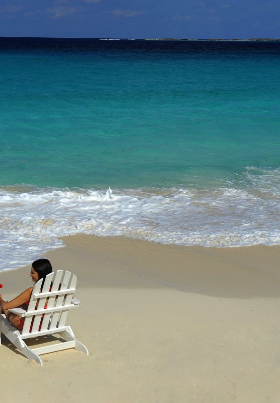 A couple sitting on Cabbage Beach in Nassau Paradise Island, The Bahamas