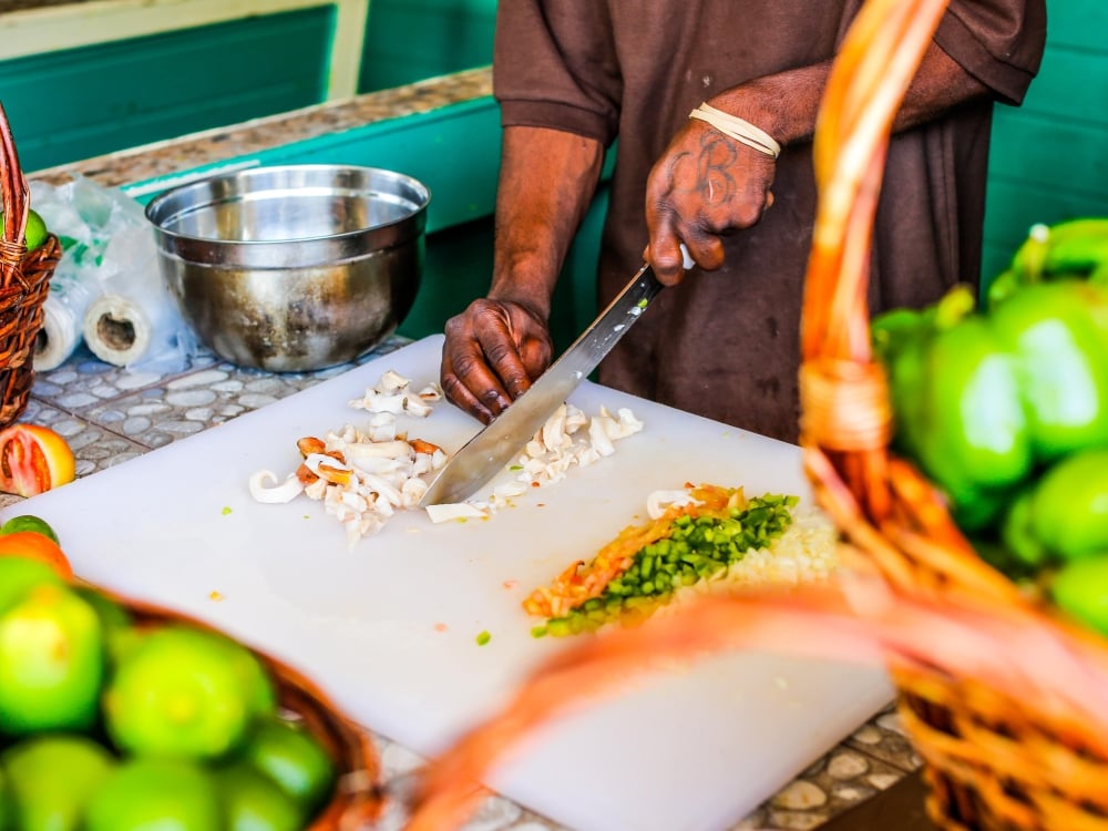 A man chopping conch for a conch salad