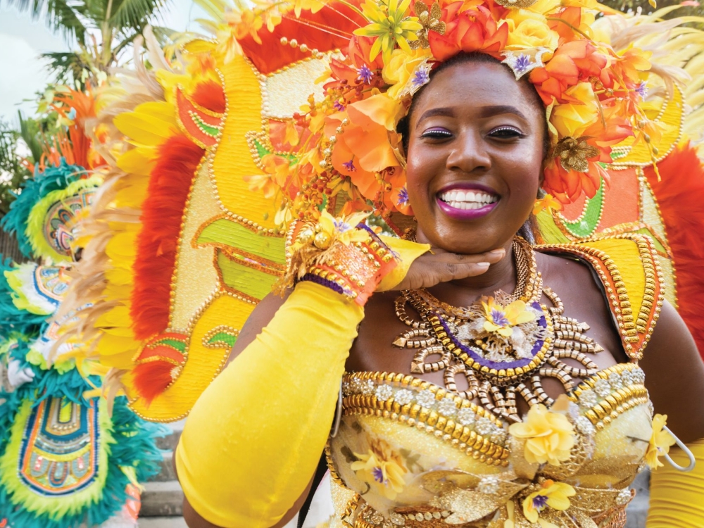 lady dressed in yellow traditional junkanoo attire