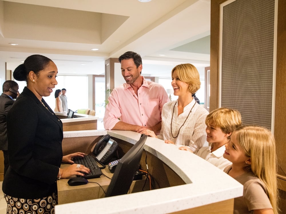 Family checking into a hotel in Nassau Paradise Island, The Bahamas